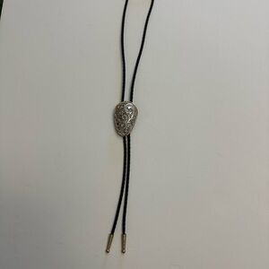 Silver Tone Western Style Bolo Tie with Gold Tone Twisted Rope Around Edge.